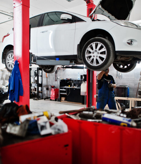 Car repair and maintenance theme. Mechanic in uniform working in Car repair and maintenance theme. Mechanic in uniform working in auto service.